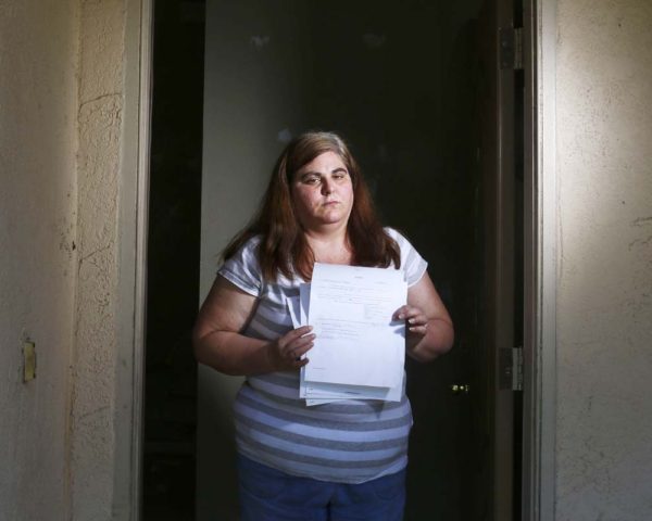 Woman holds her eviction notice