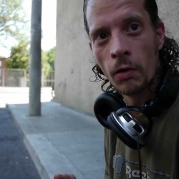 Jeffrey stood out sitting on the curb typing into a laptop. He is homeless in Toronto