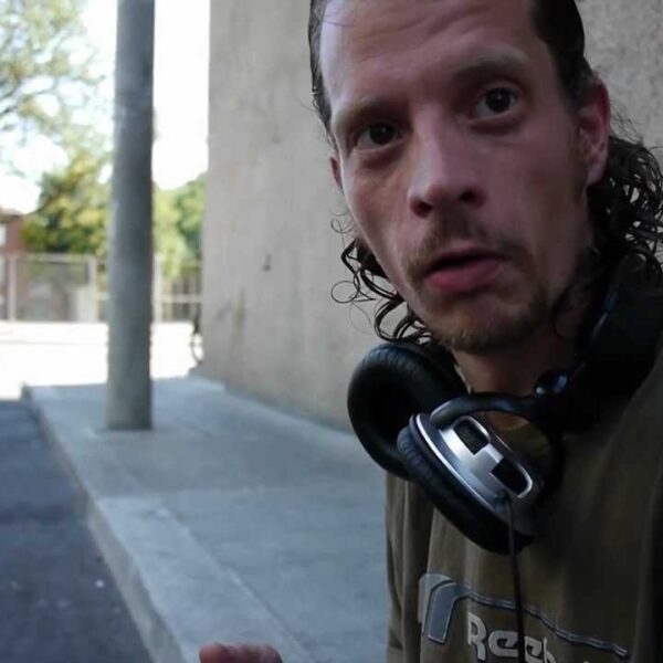 Jeffrey stood out sitting on the curb typing into a laptop. He is homeless in Toronto