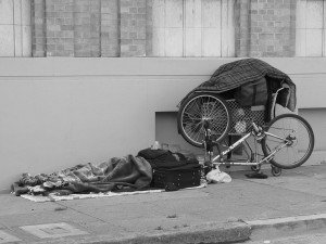 Homeless reading on the sidewalk