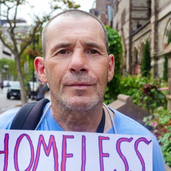 Homeless Man in Boston Flying a Sign That Reads Homeless Sober Man Seeking Human Kindness