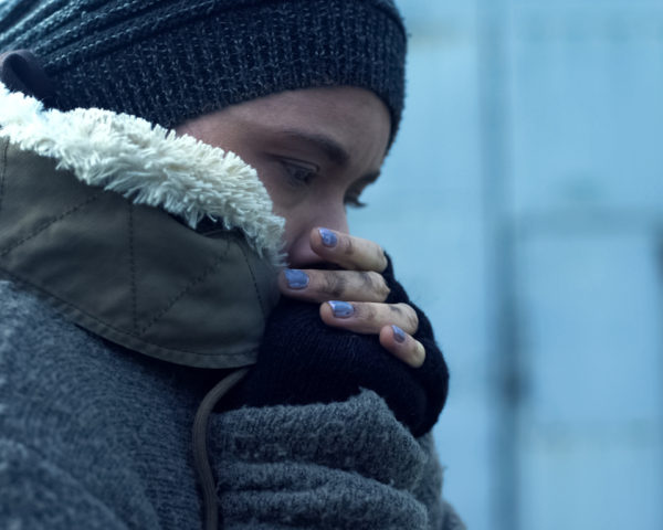 Poor woman in dirty clothes feeling cold, homeless lifestyle, hopelessness