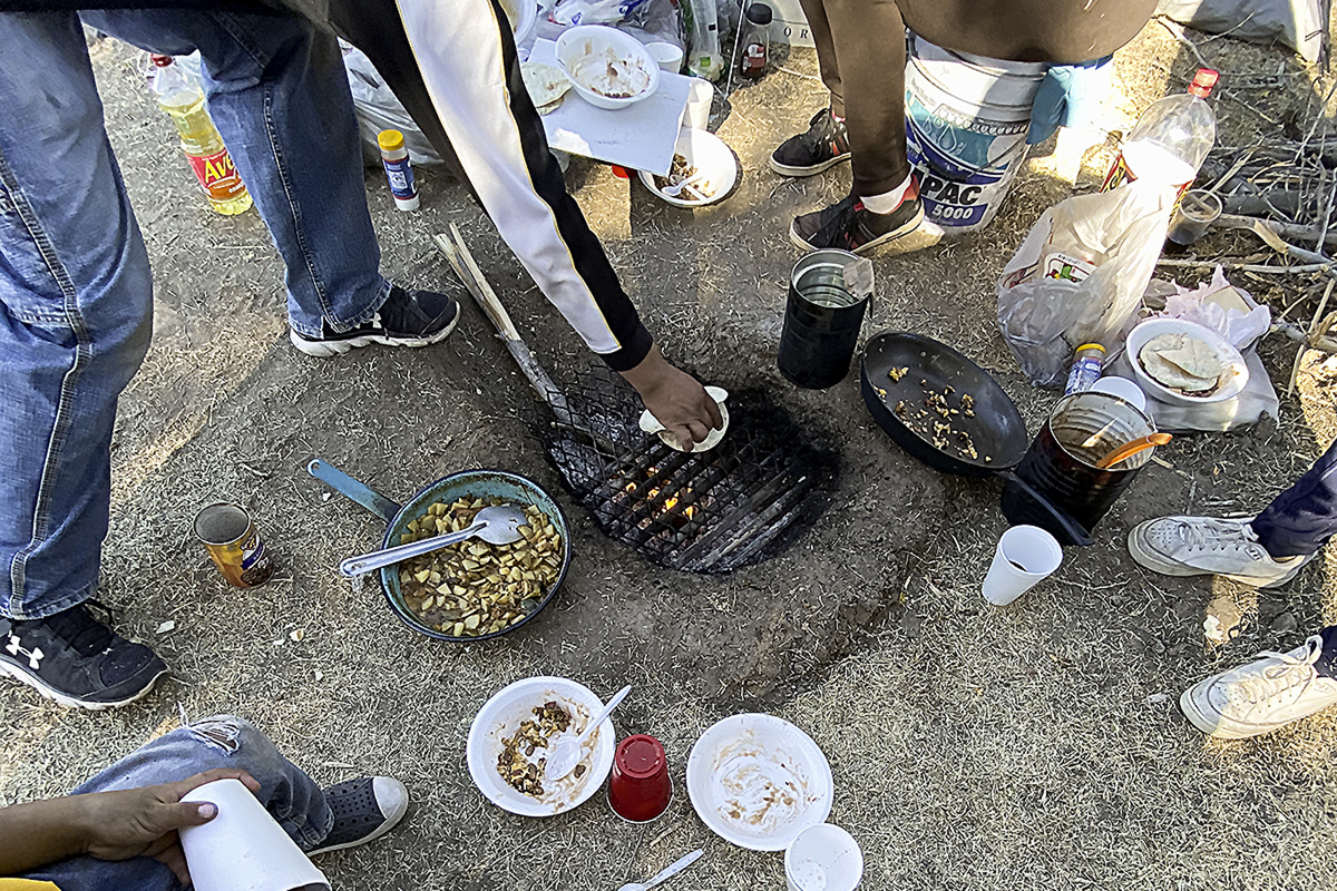 Cooking is primitive and food supplies meager in the improvised tent city near the international border.