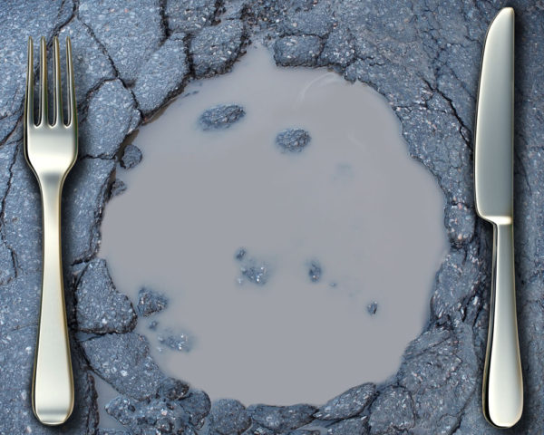 fork and knife around pothole filled with water