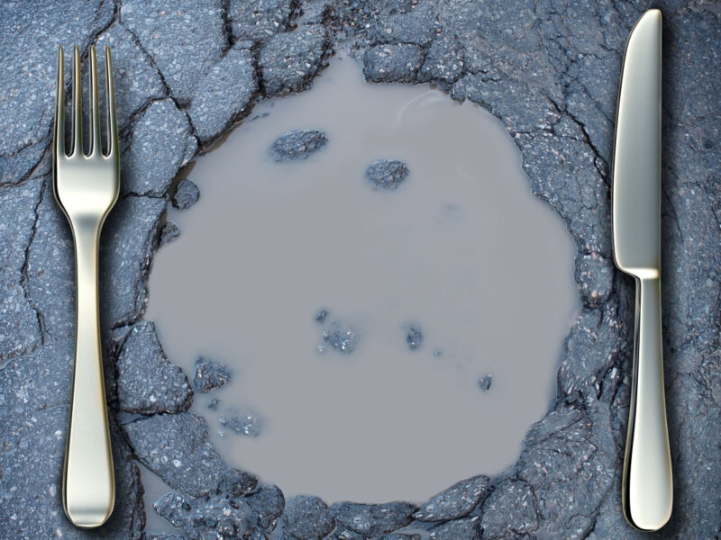 fork and knife around pothole filled with water