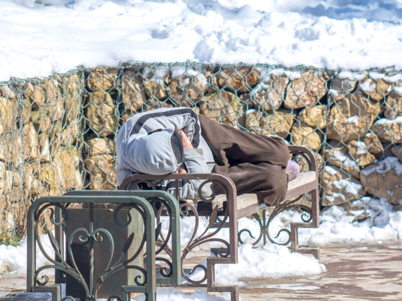 Man Sleeping outdoors in winter