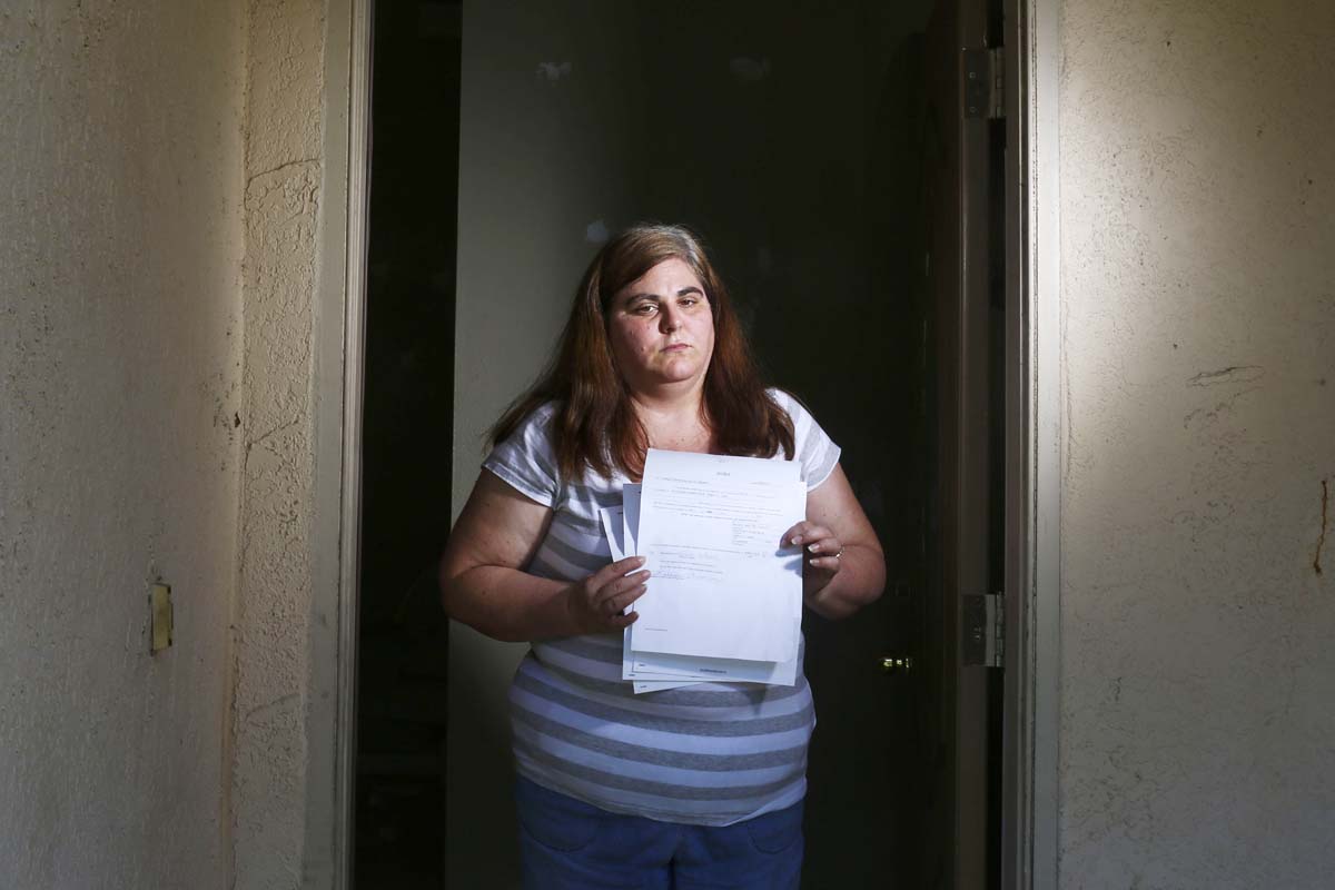 Woman holds her eviction notice