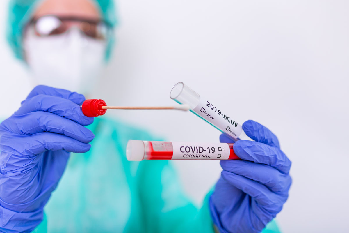 Nurse holding test tube and COVID-19 Nasal swab lab test