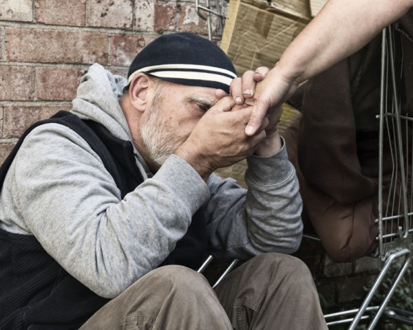 homeless man being shown compassion