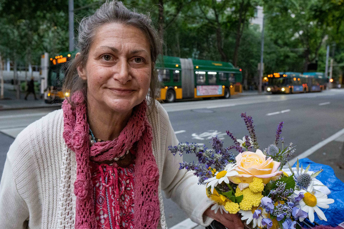 homeless woman with flowers