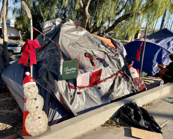 Christmas decorations on homeless person's tent
