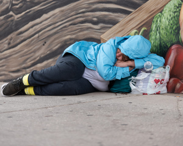 homeless woman sleeping on street