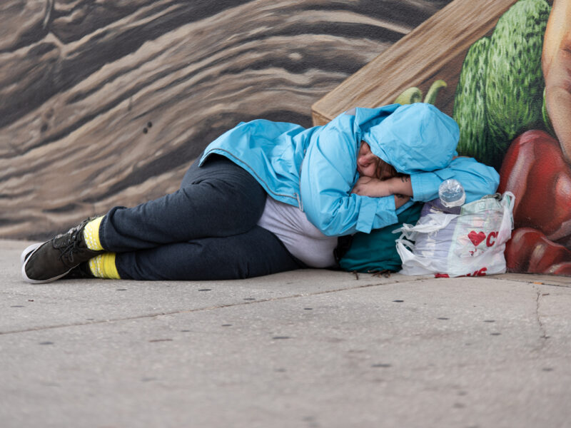 homeless woman sleeping on street