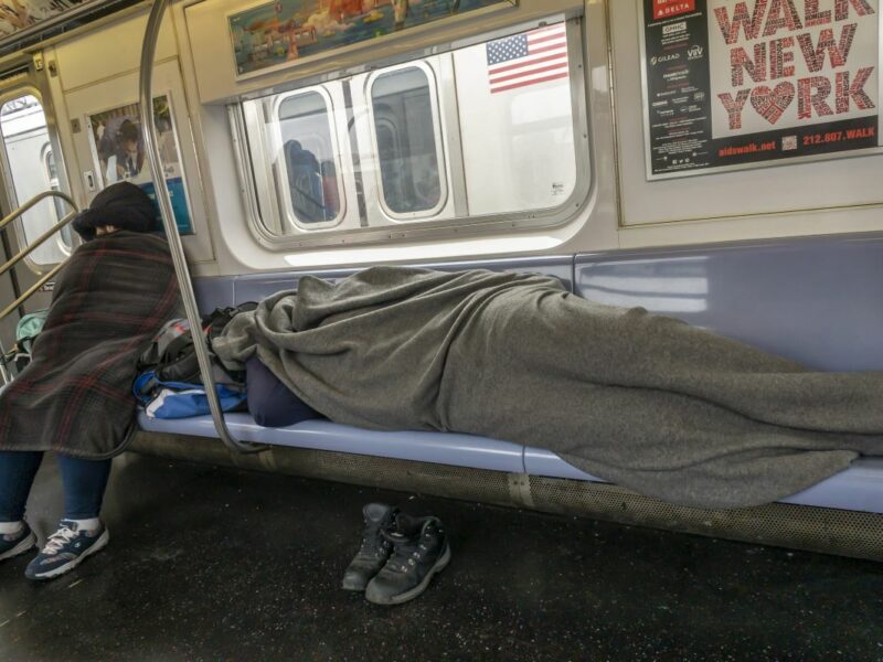 homeless people sleeping on subway