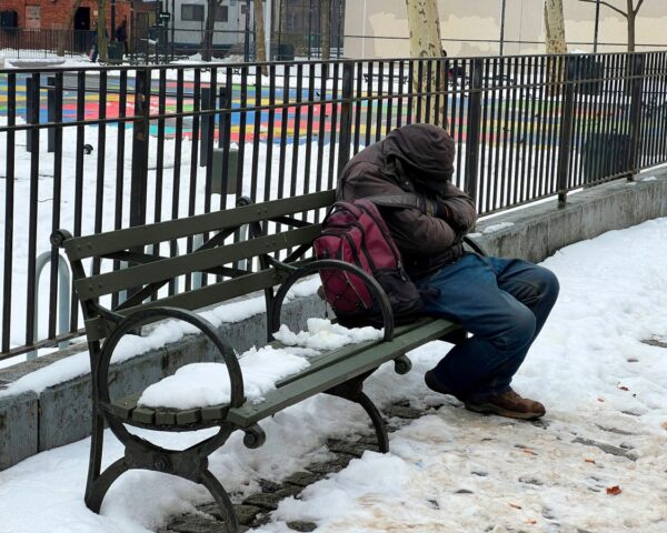 homeless person on bench in cold_
