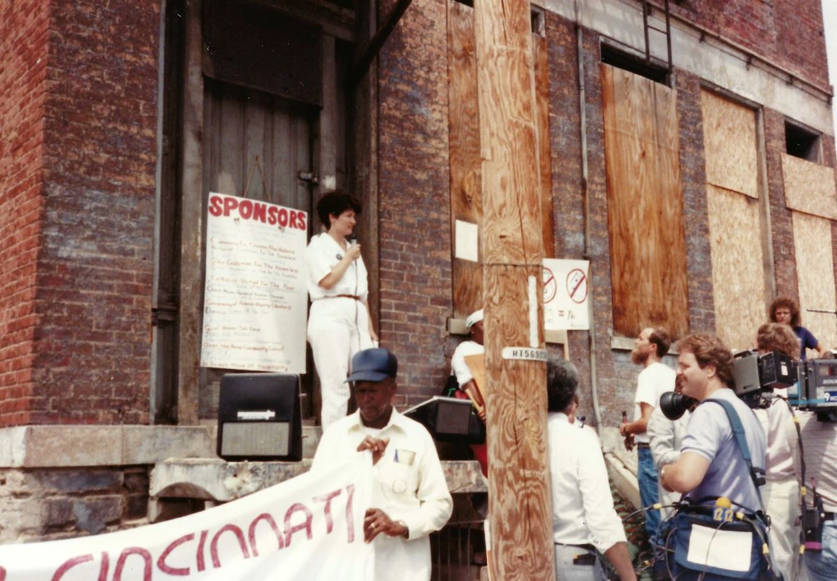 Barbara Poppe talks to the press and attendees at Take Off The Boards protest in Cincinnati during the 1980s